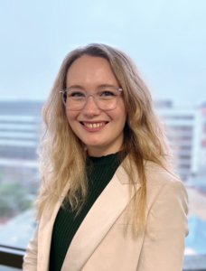 Imogen photographed smiling and looking at the camera.